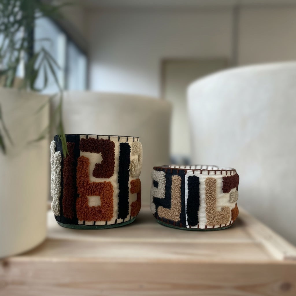 Atelier Marhaban Labyrinthe geurkaars in glazen pot met handgeweven textiel in beige, oranje en bruintinten.